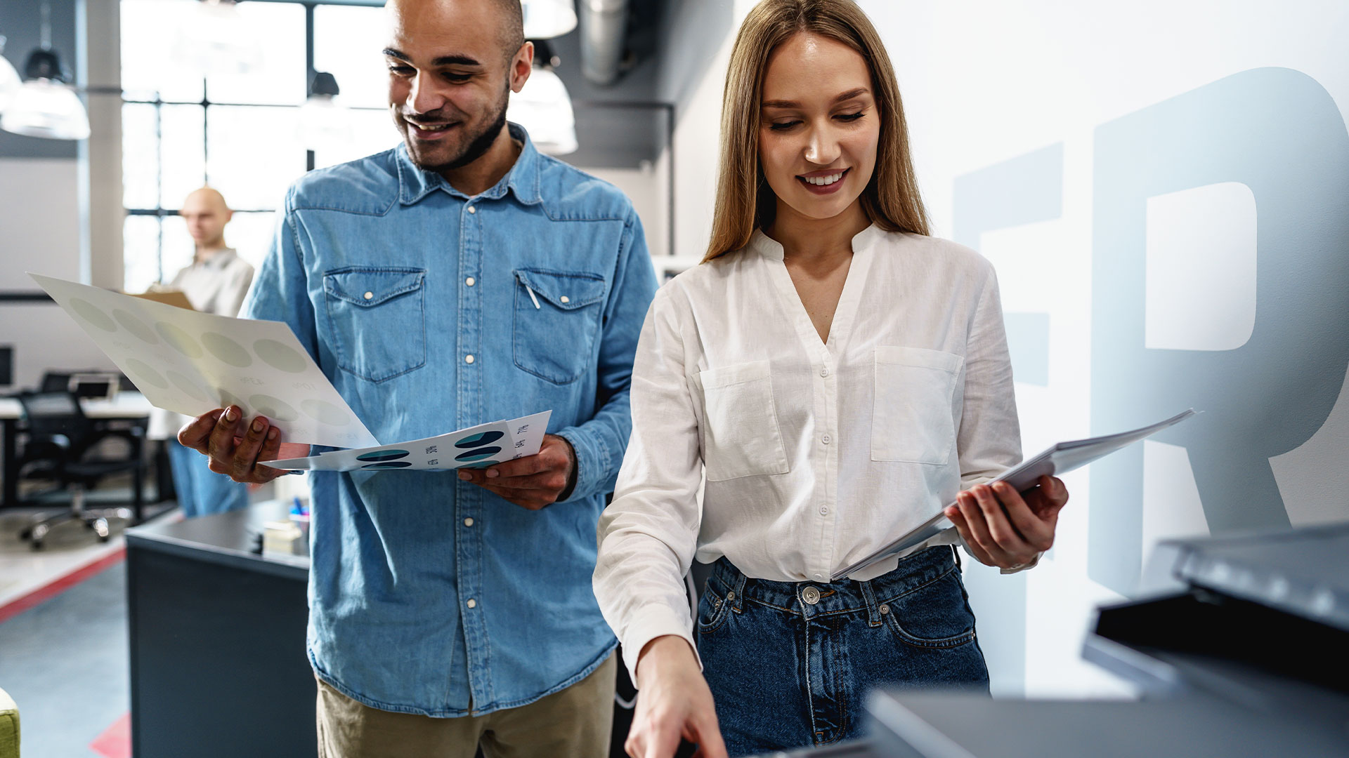 Office workers reviewing printed materials beside an Epson multifunction printer in a modern business environment